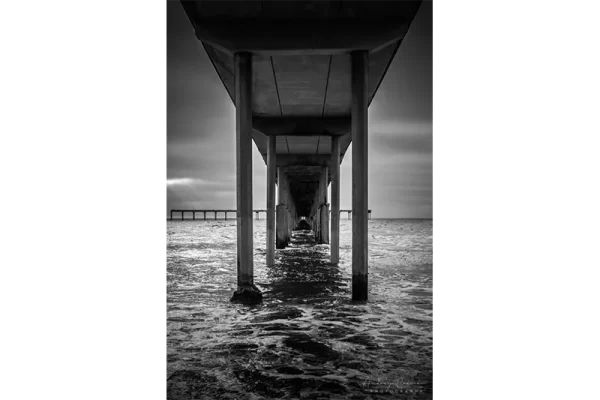 Audrey Cramer Photography's quality black and white landscape photograph of the Pacific Ocean under the San Diego California pier