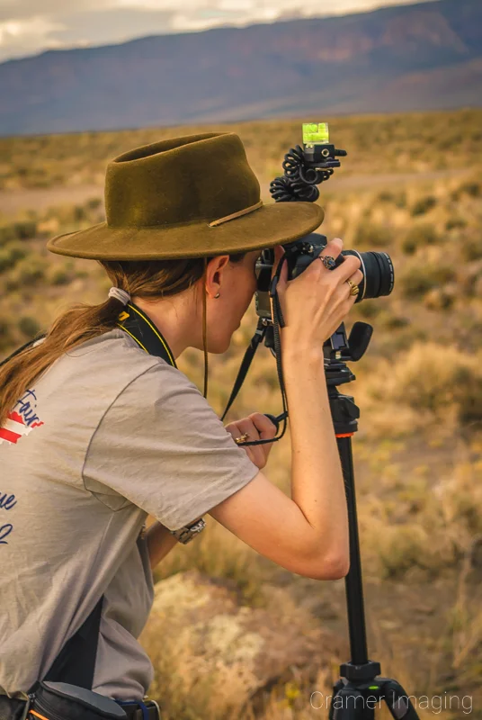 Photograph of landscape photographer Audrey Cramer shooting photos out in the Utah desert