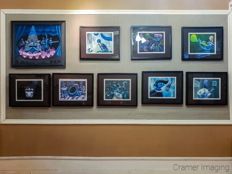 Photo of a gallery wall featuring jazzy photos which were hung crookedly