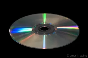 Stock photograph of a CD or compact disk on a black background