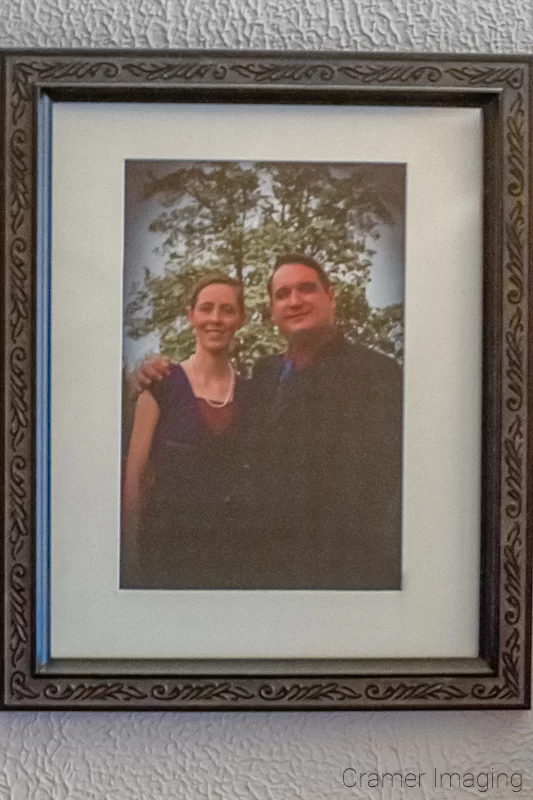 Photograph of a framed and matted photo of a couple hanging on the wall by Audrey Cramer Photography