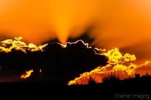 Cramer Imaging's professional landscape photograph of a dramatic orange sunset with clouds in silhouette