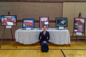 Audrey with Cramer Imaging's framed and matted fine art photographs at the "Expressions of Light" art exhibition in Pocatello, Idaho