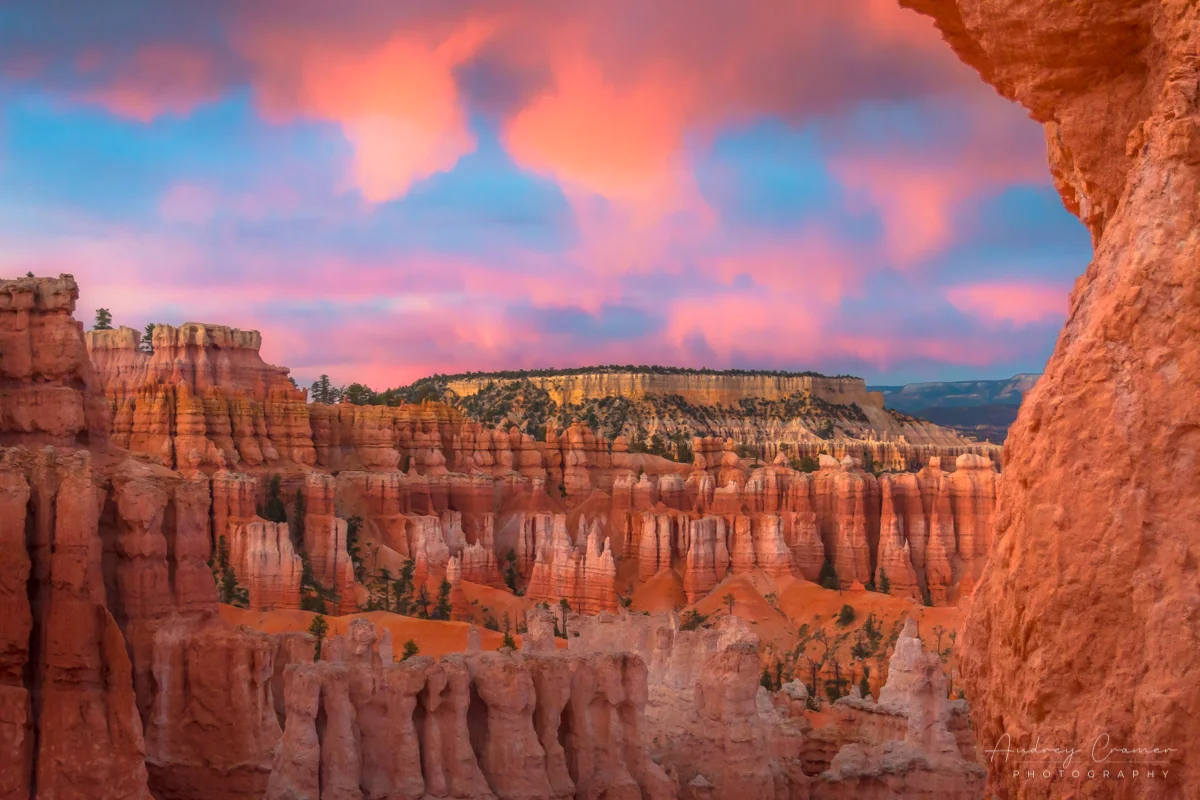 Cramer Imaging's fine art landscape photograph of fiery orange clouds lighting up over the Boat Mesa in Bryce Canyon National Park Utah