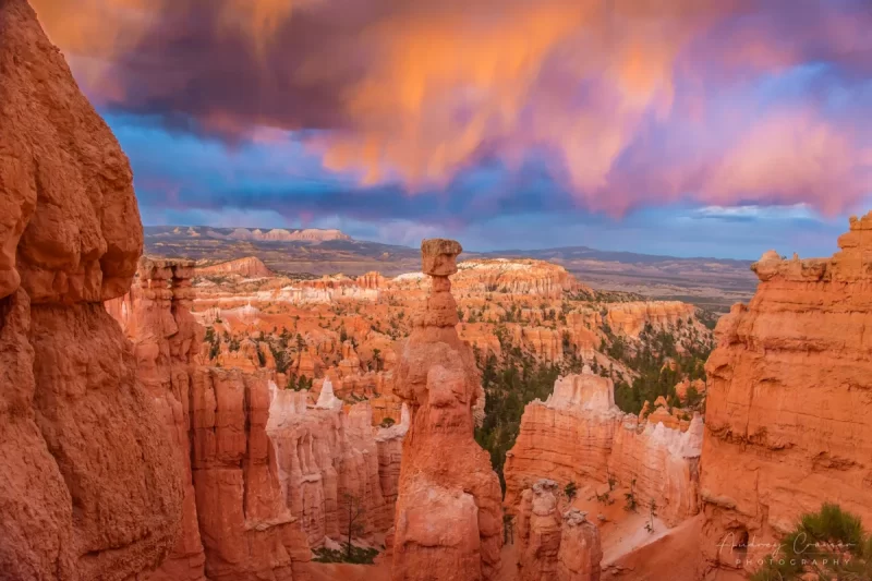 Audrey Cramer Photography's fine art landscape photograph of fiery orange clouds lighting up Thor's Hammer in Bryce Canyon National Park Utah