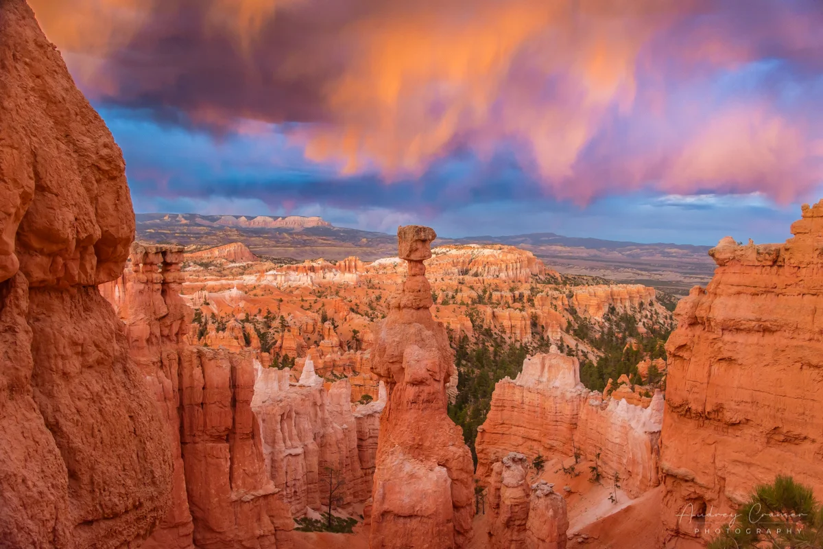 Cramer Imaging's fine art landscape photograph of fiery orange clouds lighting up Thor's Hammer in Bryce Canyon National Park Utah