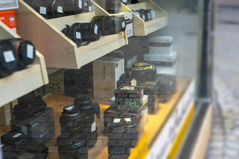 Photograph of looking a camera equipment for sale or repair through a window