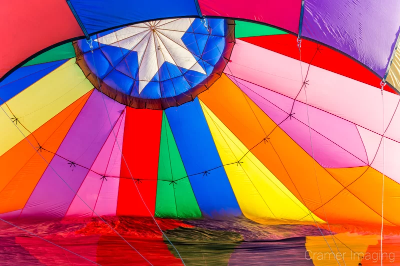 Audrey Cramer Photography's fine art photograph of the inside of a colorful hot air balloon inflating with air