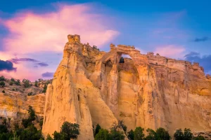 Cramer Imaging's fine art landscape photograph of the Grosvenor Arch of Escalante National Monument Utah at sunset with dramatic skies