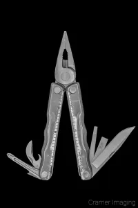 Cramer Imaging's photograph of a Leatherman or multi-tool against a black background