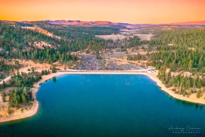 Aerial landscape photograph of the Tropic Reservoir, dam, and surrounding landscape in Garfield Utah