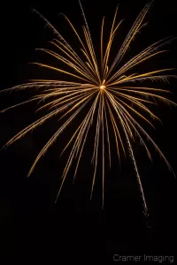 Cramer Imaging's fine art photograph of a single firework in the night sky on the 4th of July