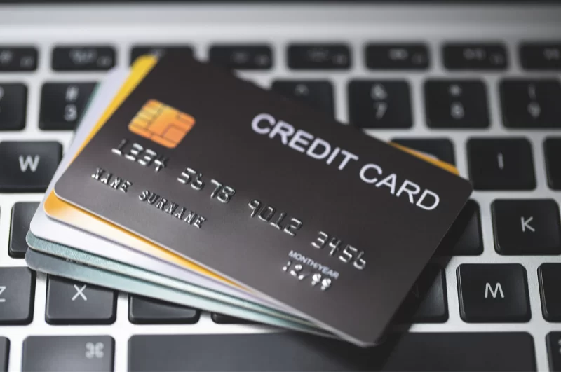 Photograph of fictional credit cards sitting on a computer keyboard