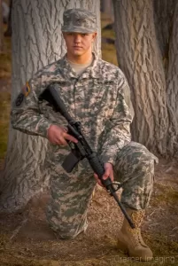 Senior portrait of a soldier in the Army Reserves holding a rifle at Ross Park, Pocatello, Bannock, Idaho professionally photographed by Cramer Imaging