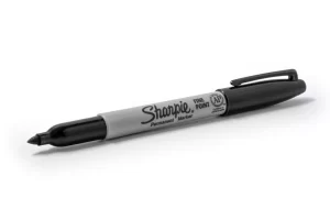 Photograph of a black open Sharpie brand marker on a white background