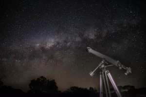 Photo of the Milky Way with a telescope in the foreground