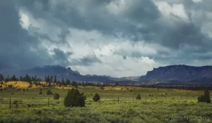 Cramer Imaging's fine art landscape photograph of moody storm clouds hanging over a gap in the mountains in Bryce City, Utah