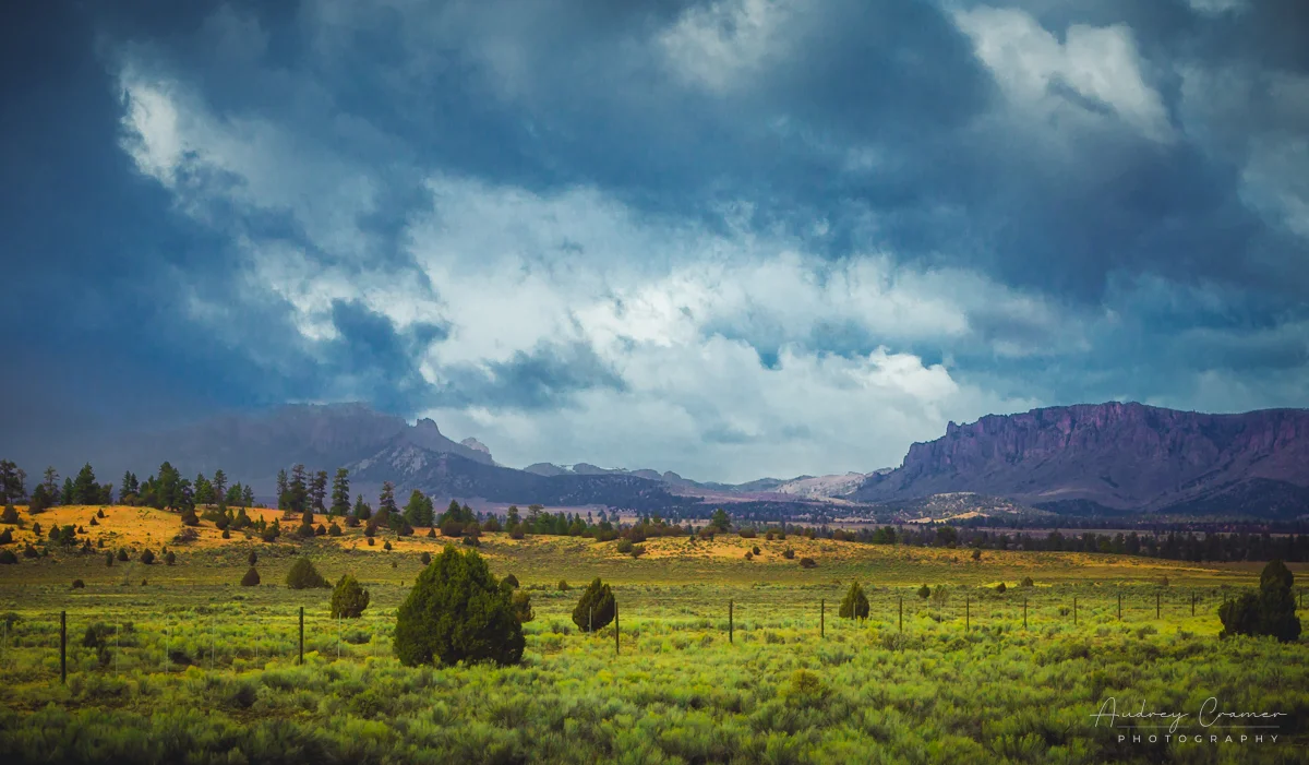 Audrey Cramer Photography's fine art landscape photograph of moody storm clouds hanging over a gap in the mountains in Bryce City, Utah