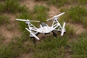 Photograph of a drone sitting on the ground getting ready to fly