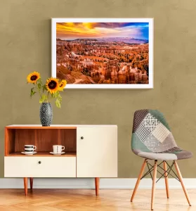 Photo of Cramer Imaging's "Sunset at Bryce" on the wall of a warm-toned room with a chair and desk