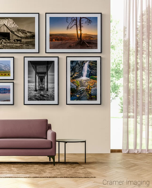 Photograph of several Audrey Cramer Photography landscape photos displayed on a gallery wall eclectic style