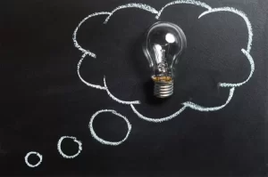 Light bulb in a thought bubble on a blackboard