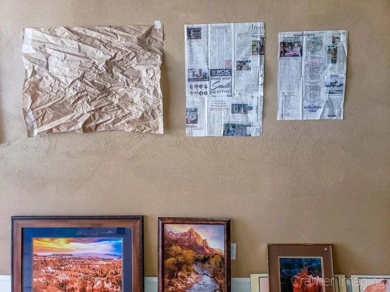 Audrey Cramer Photography's photograph of newspaper templates on the wall arranged to hang a gallery wall presentation with the pictures below