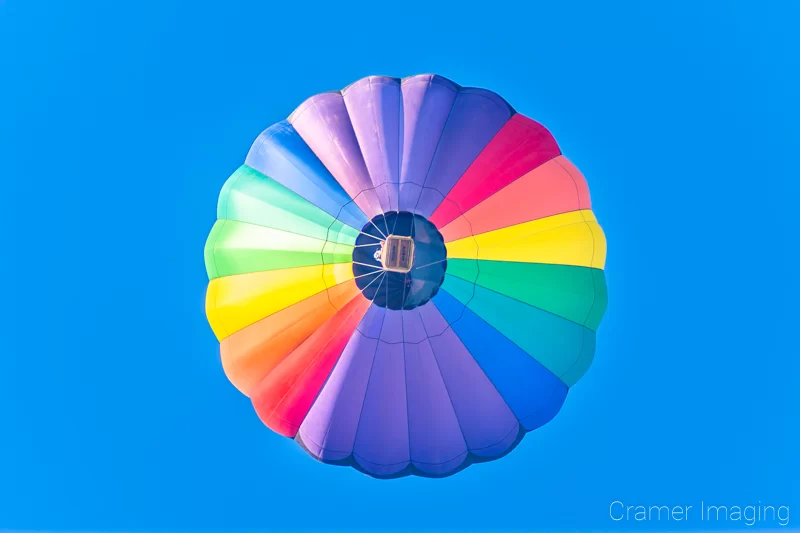 Fine art photograph of a soaring hot air balloon against the blue sky in Panguitch, Utah by Audrey Cramer Photography