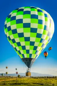 Fine art landscape photograph of a bright hot air balloon flying over a fence in Panguitch, Utah, by Cramer Imaging