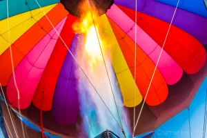 Fine art photograph of a propane jet blowing fire up a colorful hot air balloon in Panguitch, Utah by Cramer Imaging