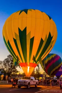 Fine art photograph of a balloon glow with 3 visible hot air balloons in Panguitch, Utah by Cramer Imaging