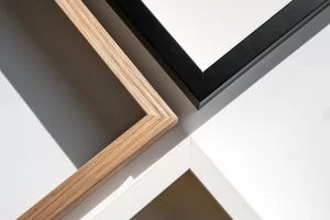 Photograph of 3 different colored picture frames grouped into a grid