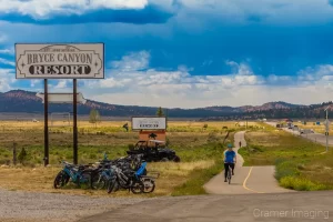 Photograph of a bicyclist on a trail near a road close by Bryce Canyon National Park Utah