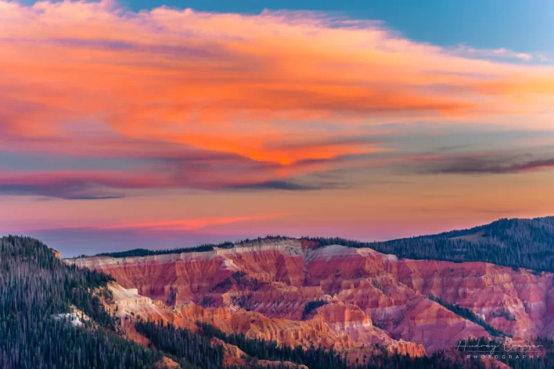 Audrey Cramer Photography's fine art landscape photograph of fiery orange sunset clouds glowing over Cedar Breaks National Monument Utah