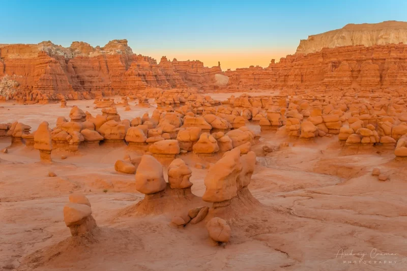 Audrey Cramer Photography's fine art landscape photograph of orange mushroom-shaped hoodoo rocks at sunset at Goblin Valley State Park Utah