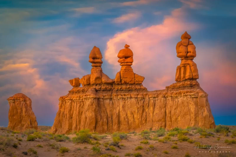 Audrey Cramer Photography's fine art landscape photograph of the orange hoodoo rock formation called Three Sisters at sunset at Goblin Valley State Park Utah