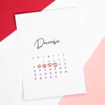 Calendar of the month of December with 4 dates circled on a colored background