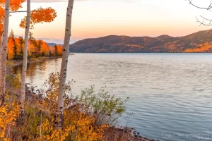 Cramer Imaging's fine art landscape photograph of sunset and golden autumn leaves at Fish Lake, Utah