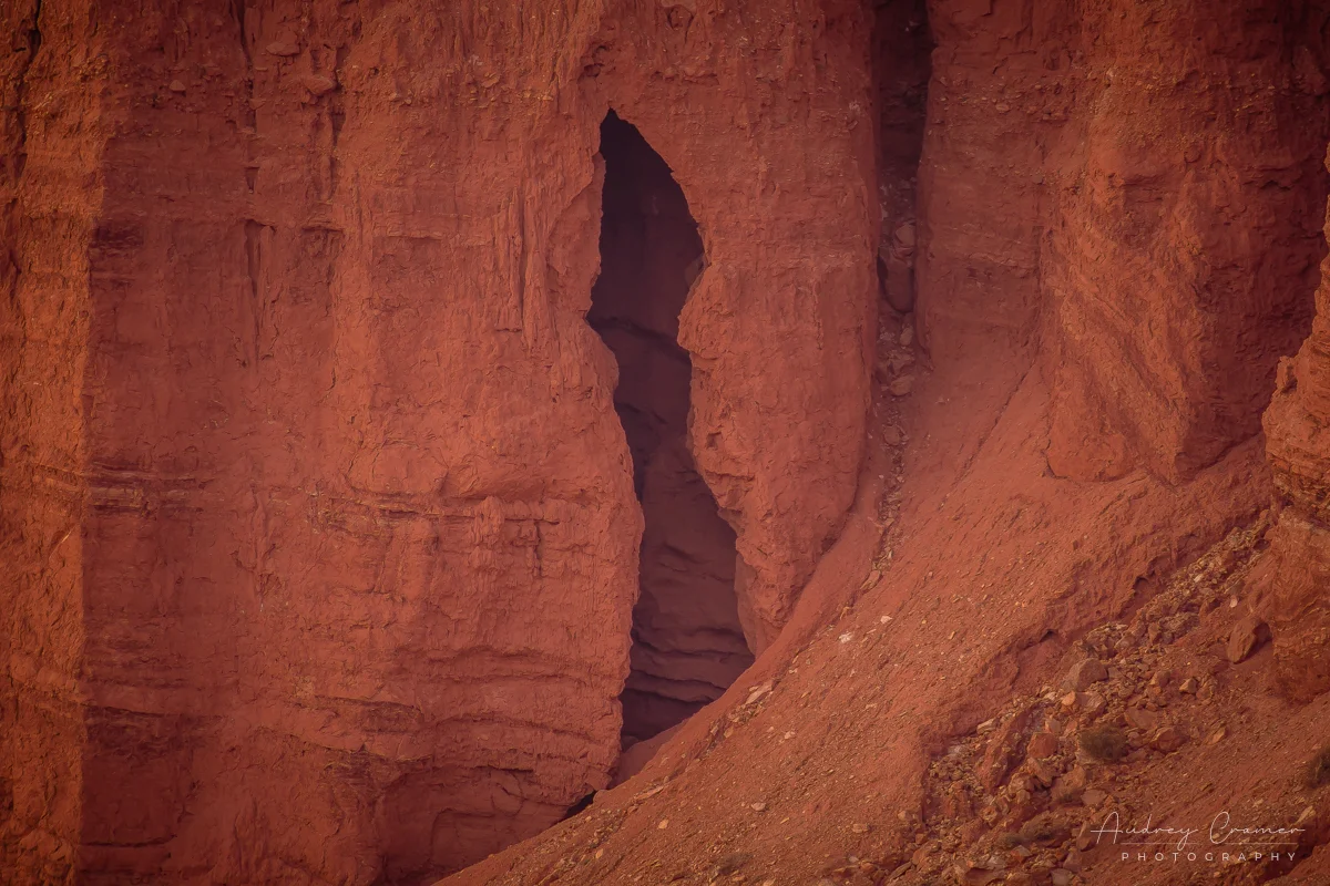 Audrey Cramer Photography's fine art landscape photograph of a hole or cave in red rock at Capitol Reef National Park Utah