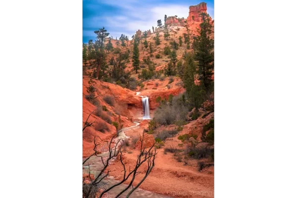 Cramer Imaging's fine art landscape photograph of a waterfall and red hoodoos at Bryce Canyon National Park, Utah