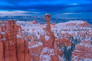 Fine art landscape photograph of snowy Thor's Hammer hoodoo in Bryce Canyon National Park in Utah during winter and twilight