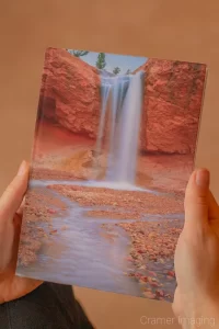 Photograph of hands holding a book with Audrey Cramer Photography's landscape photograph "Ethereal" on the cover