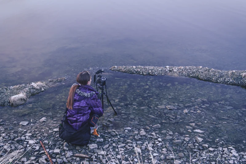 Landscape photographer Audrey Cramer setting up a landscape photo at Henry's Lake Idaho