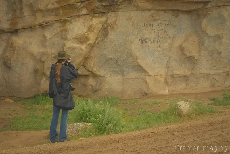 Audrey Cramer Photography's professional landscape photographer Audrey Cramer photographing the pioneer signatures on Signature Rock at City of Rocks, Idaho