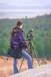 Landscape photographer Audrey standing on the slopes of Bryce Canyon National Park Utah taking a photo