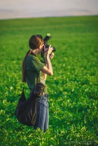 Cramer Imaging's behind-the-scenes photo of Audrey with a camera in a potato field in Idaho