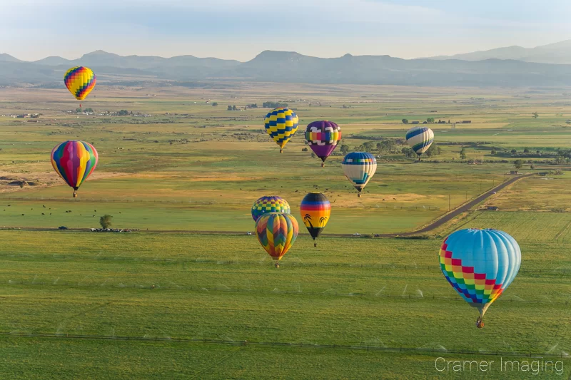 Audrey Cramer Photography's fine art aerial photograph of a hot air balloon cluster floating over a field in Panguitch Utah