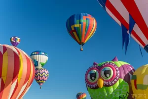 Cramer Imaging's fine art photograph of many hot air balloons taking flight in Panguitch Utah with a blue morning sky