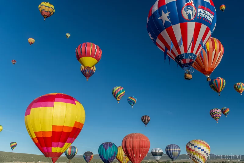 Audrey Cramer Photography's fine art photograph of lots of hot air balloons taking flight in Panguitch Utah with a blue morning sky