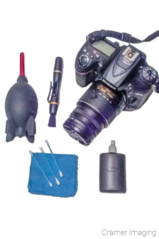 Audrey Cramer Photography's photograph of a camera and camera cleaning kit on a white background